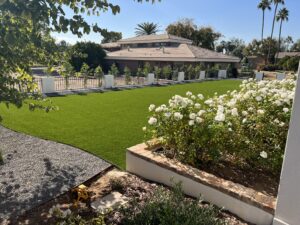 mason block wall with new iron fence and green artificial turf in Arcadia, Arizona