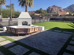 new fireplace build with new brick pavers and synthetic lawn