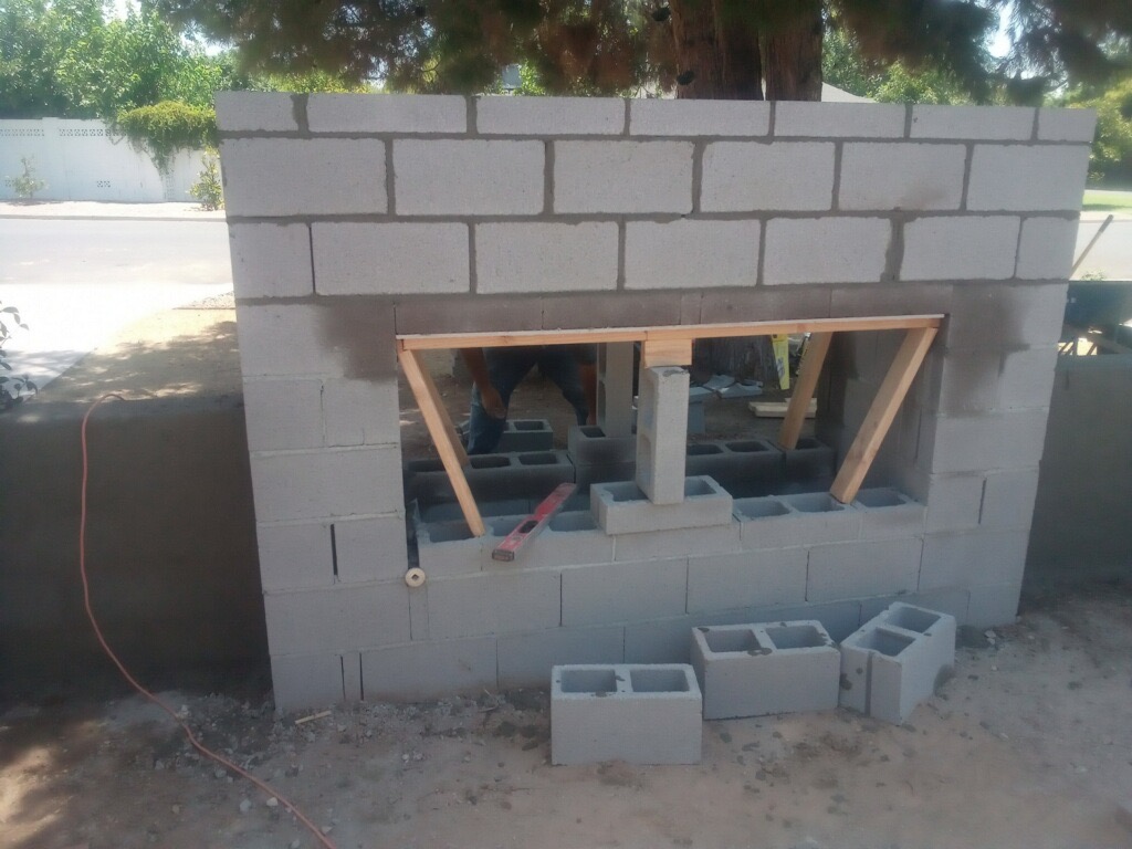 outdoor living space in Arcadia during custom gas fire place and wall build